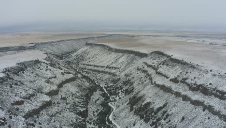 Wide-drone-panning-shot-of-snowy-canyon-in-Idaho