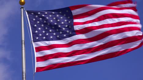 the us flag flies in the wind