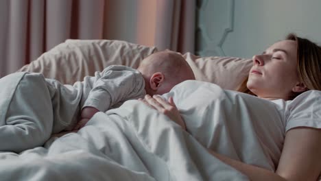 mother and baby sleeping in bed