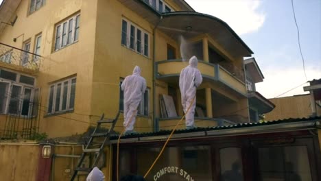 white kit wearing frontline men warriors are in a single line and ready to fight against coronavirus and sanitize srinagar india