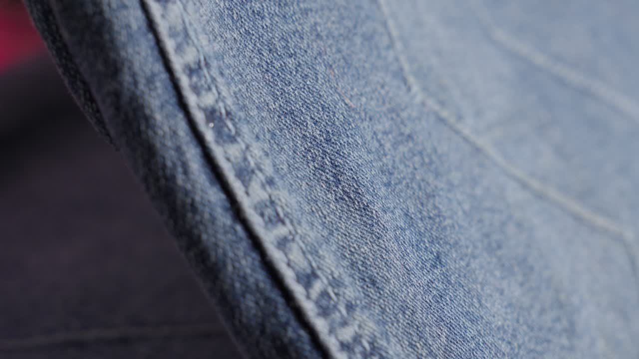Close-up of a Hand Ironing Jeans