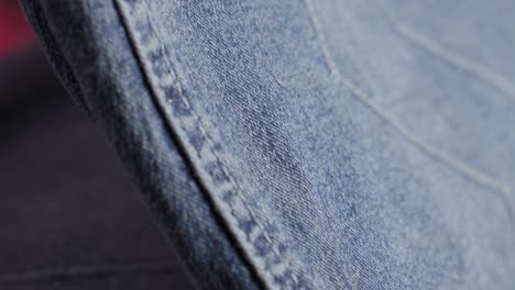 close-up of a hand ironing jeans