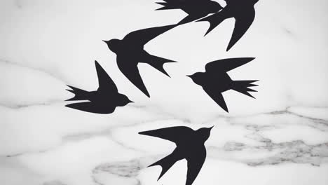 silhouettes of birds flying against a marble background