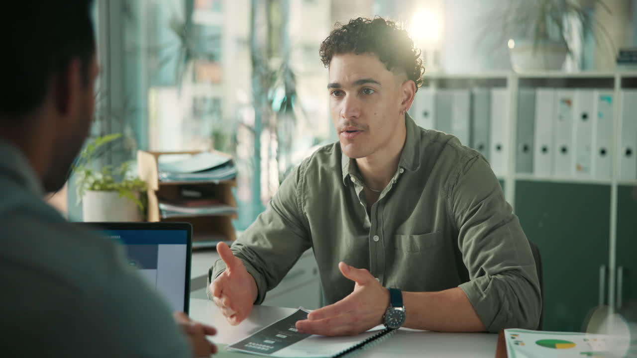 Young Man Explaining Business Strategy During an Office Meeting