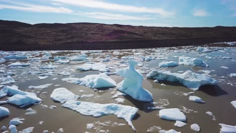 slow aerial across the massive glacier lagoon filled with icebergs at fjallsarlon iceland suggests global warming and climate change 15