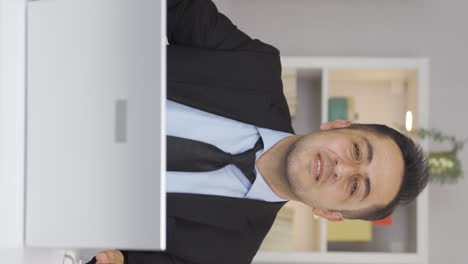 vertical video of home office worker man dances looking at camera.