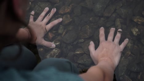 fish feeding on the hands of a woman