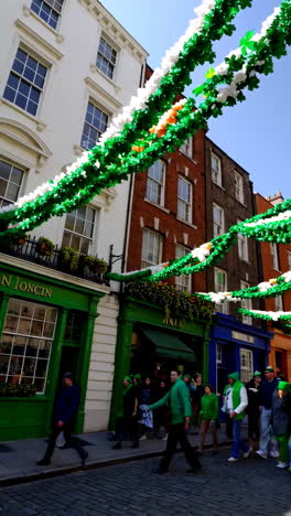 st. patrick's day celebration on a decorated city street with people