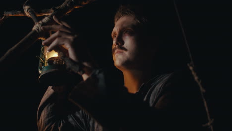 man with a lantern in the dark