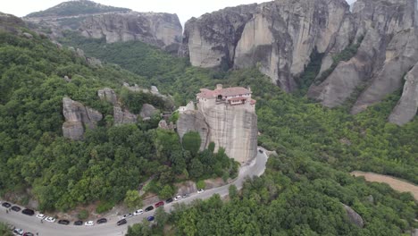 mountain road circling around monastery of rousanou on top of rock, meteora, thessaly, central greece