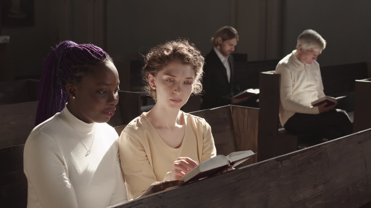 Two Multiethnic Women Reading Bible in Church