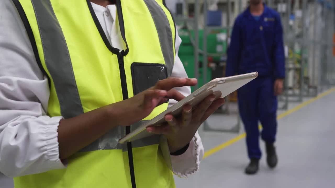 Warehouse female worker using digital tablet