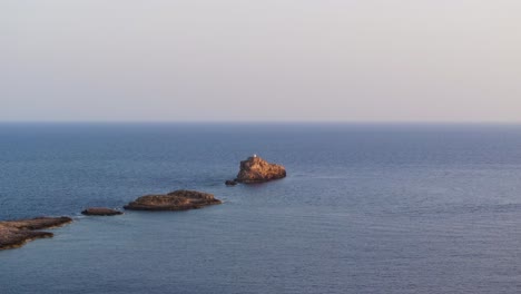 Panoramic-aerial-view-of-Punta-de-El-Toro-path-into-sea,-Balearic-Islands