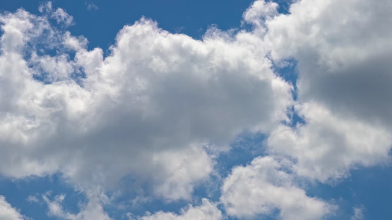 Clouds float in the sky during a sunny afternoon