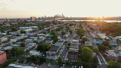 Wonderful neighborhood of Camden in New Jersey with green trees along roadside summer. Skyline of Philadelphia and famous Benjamin Franklin bridge in distance. Quiet and peaceful atmosphere in USA