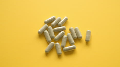 lions mane supplement pill from yellow table