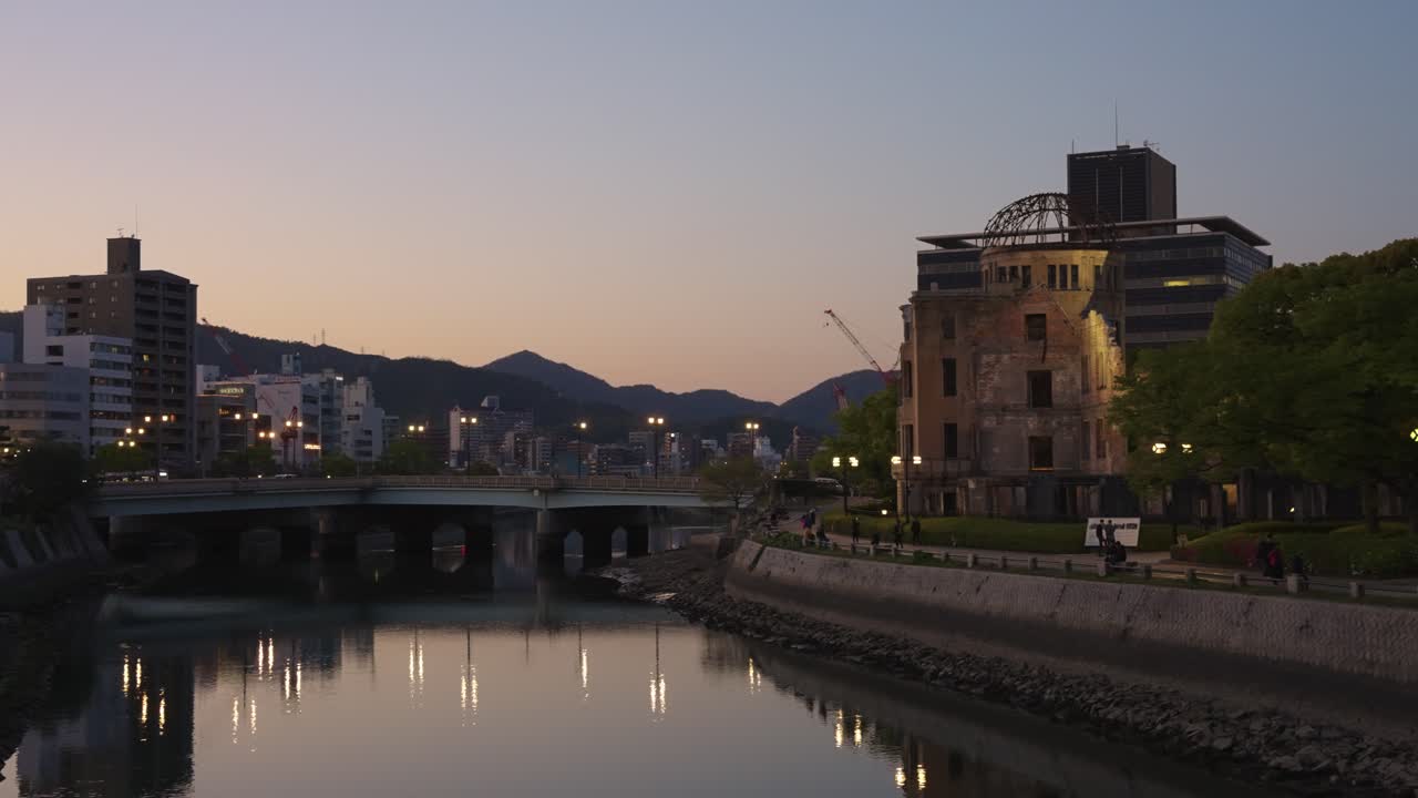 estableciendo una toma panorámica de la cúpula atómica de hiroshima, parque de la ciudad al anochecer 4k