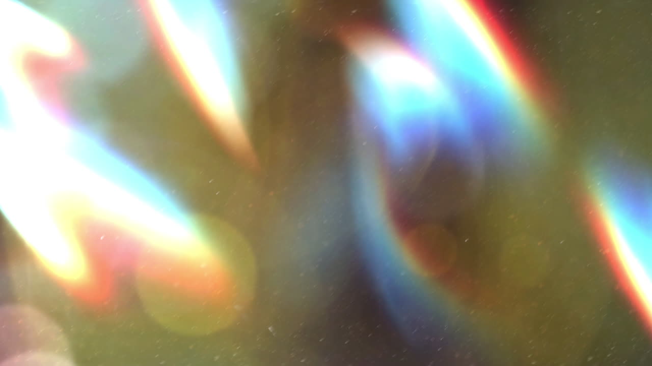 Perdite di Luce Astratte e Bagliori dell'Obiettivo Arcobaleno con Particelle di Polvere