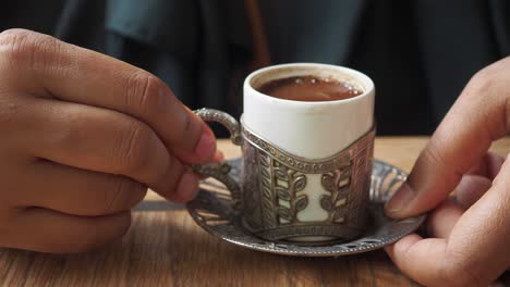 una persona sosteniendo una taza de café turco