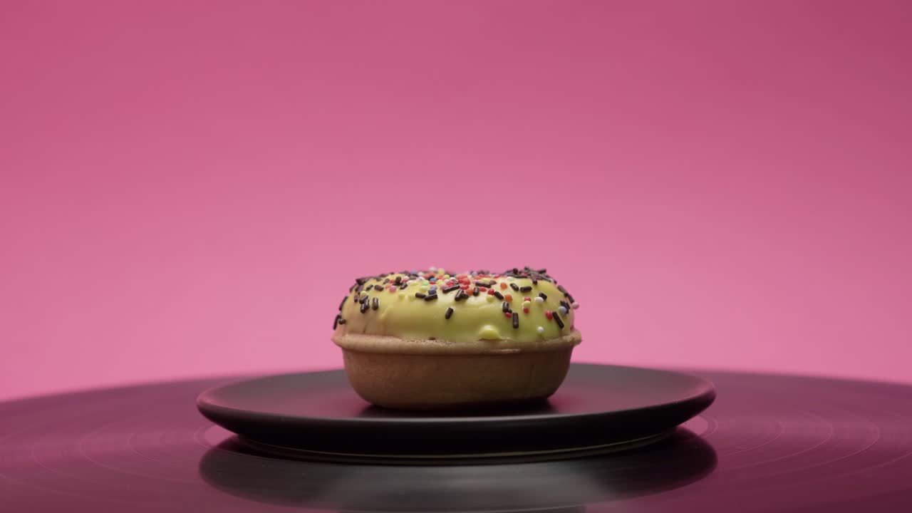 Delicious American donut with yellow sweet topping and choco and colorful crumbs