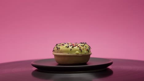 delicious american donut with yellow sweet topping and choco and colorful crumbs