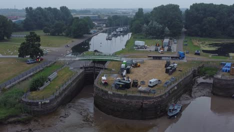 Luftaufnahme-Spike-Island-Council-Arbeiter-Entfernen-Auferstehungskonzertbarrieren-Vom-River-Canal-Park-Unten-Links-Dolly