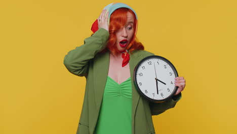 redhead woman with anxiety checking time on clock, running late to work, being in delay, deadline