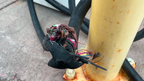frayed wires at a charging station for electric cars