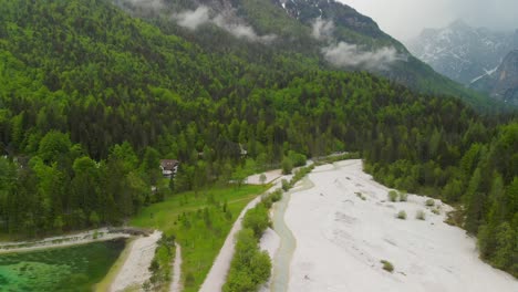 Aerial-shot-of-a-turquoise-coloured-lake-in-the-mountains-of-Slovenia