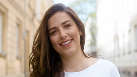 Portrait-Of-A-Beautiful-Woman-Smiling-And-Looking-At-Camera-In-The-Old-Town-Street