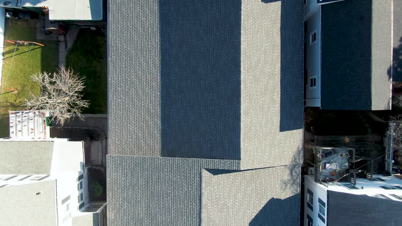 Zoom out from roof of house in suburban neighborhood, Peabody, Massachusetts