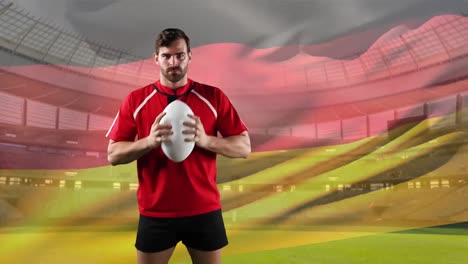 professional rugby player standing in front of a flag and stadium