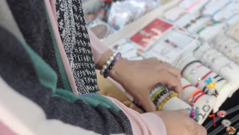 woman selling bracelets at a street market