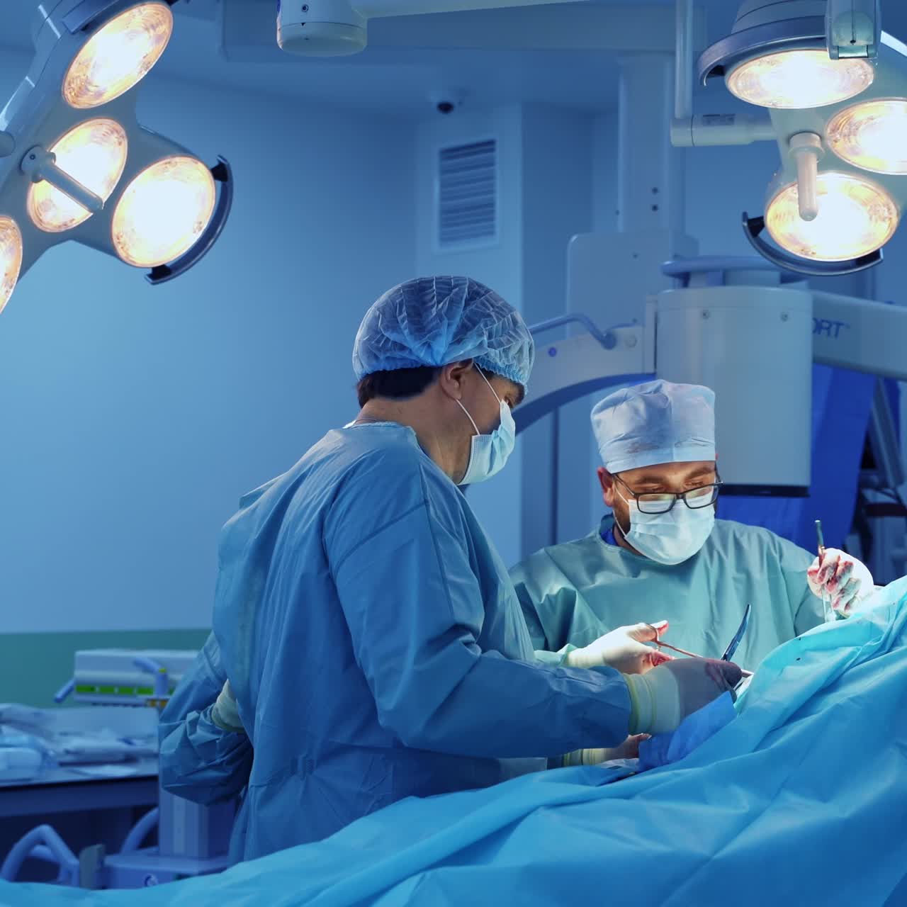 Surgical team stand around the surgical table. Doctors collaborating at orthopedic operation