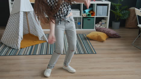 teenage girl dancing in kids room with headphones