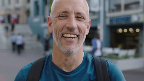 portrait-of-mature-attractive-caucasian-tourist-man-looking-at-camera-laughing-city-background