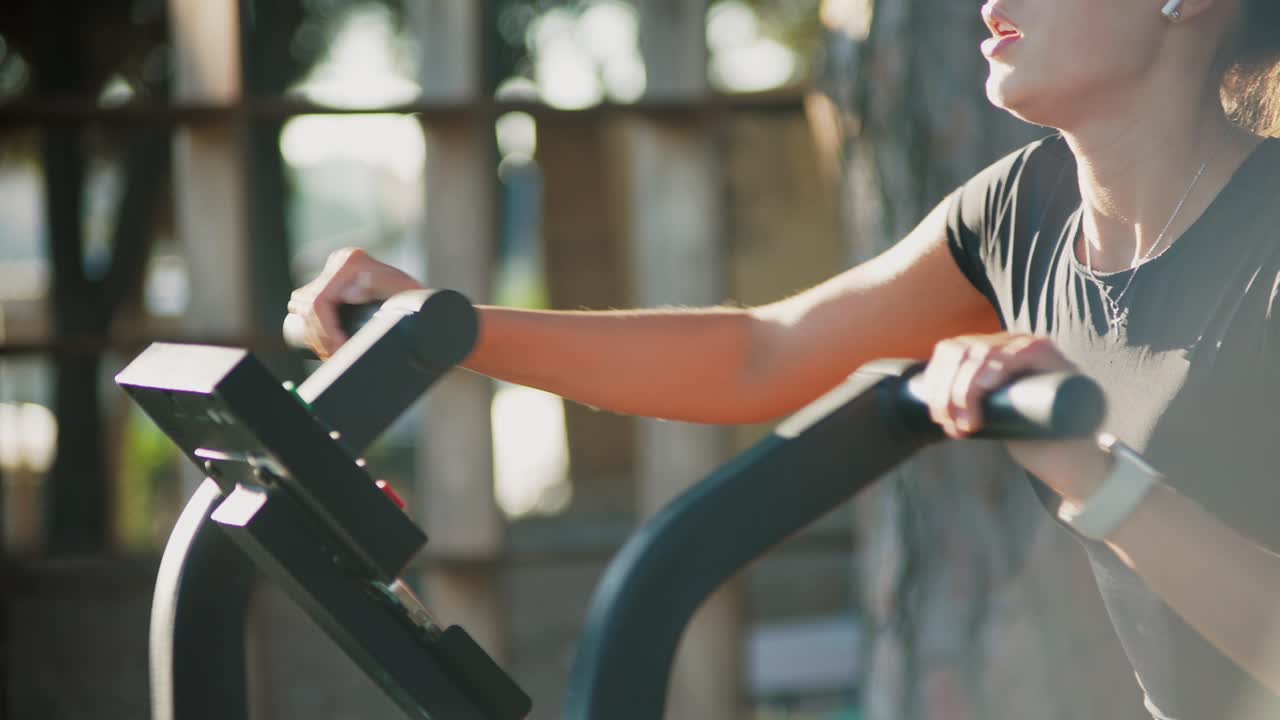 Woman using elliptical machine for exercise