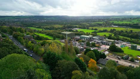 Aerial-view-approaching-a-UK-chemical-plant-with-pipes,-metal-structures,-cooling-towers,-and-chemical-storage