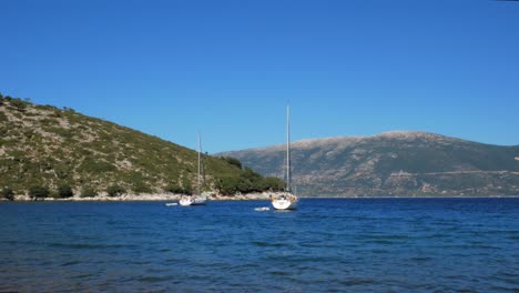 sailboats floating on calm blue sea near agia eleni beach in greece