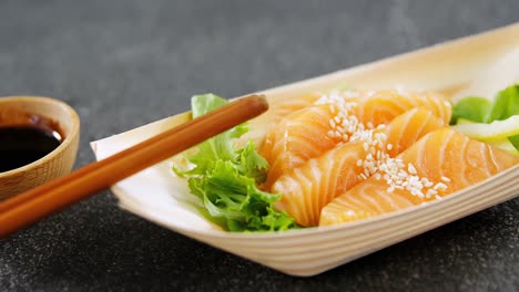 Sushi-on-boat-shaped-plate-with-chopsticks