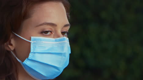 [camera used: canon c300] close-up caucasian woman wearing a surgical face mask