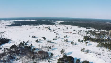 distant view on radio kootwijk cathedral in netherlands, drone view on snowy winter day