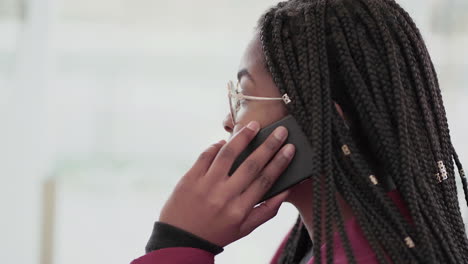 Side-view-of-Afro-American-young-girl-with-plump-rose-lips-and-braids-in-aviator-eyeglasses-wearing-rose-coat