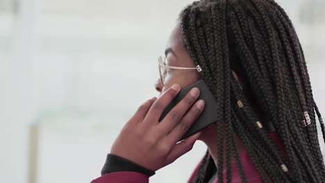 side view of afro-american young girl with plump rose lips and braids in aviator eyeglasses wearing rose coat