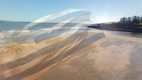 animación de la bandera de uruguay ondeando sobre la playa soleada y el mar