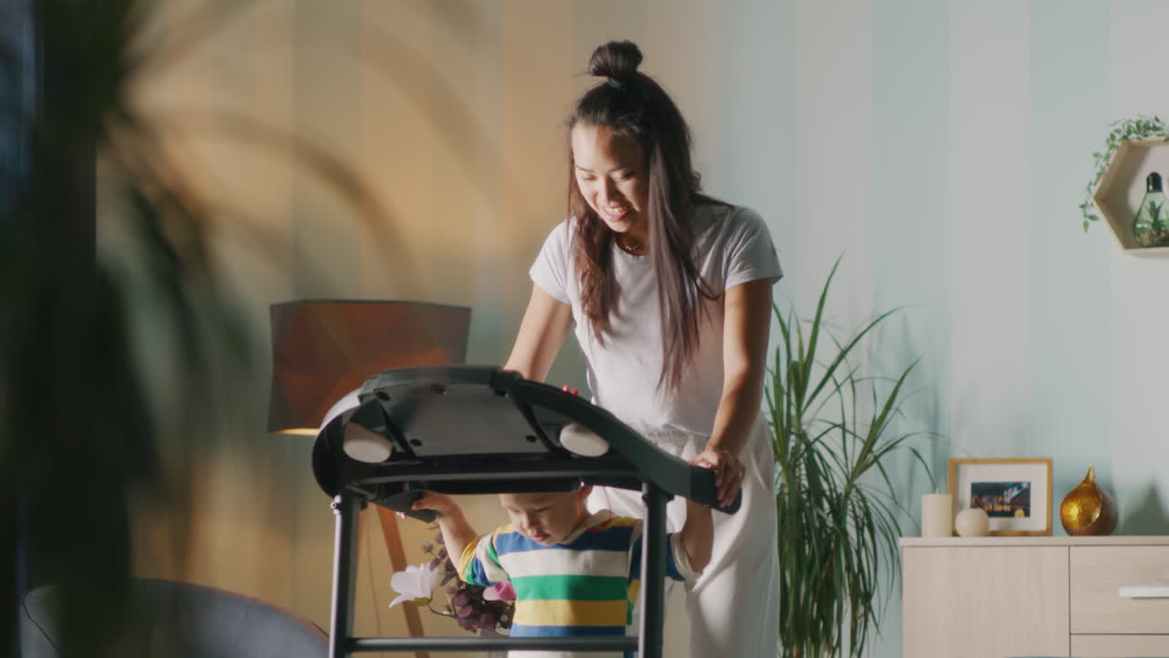 Mother and Child Exercising on Treadmill at Home
