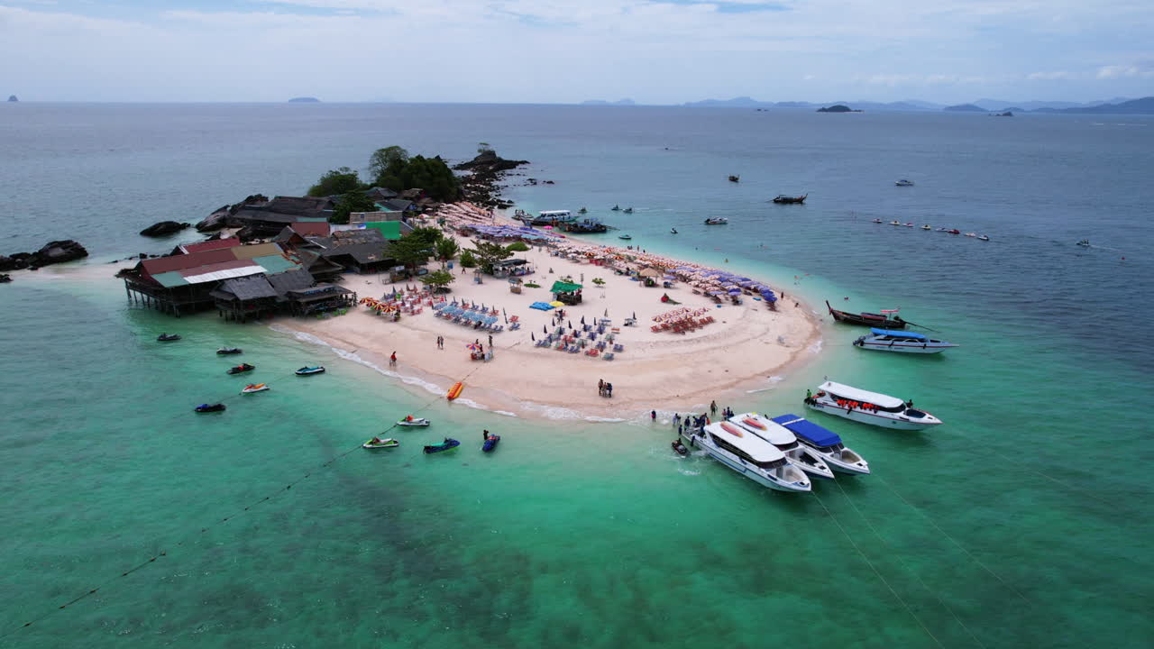 Drone pull back full view of Koh Khai Nok island, in Thailand, sunny day