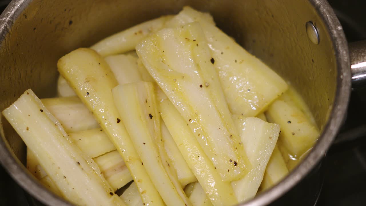 Delicious Parsnips in a Pan Par Boiled and Covered in Butter and Cracked Black Pepper Ready to Roast for Family Dinner Feast 4K.