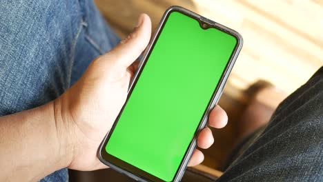 close up of young man hand using smart phone