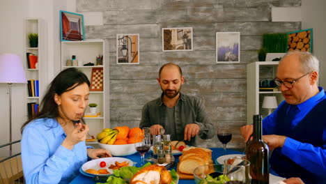 Zoom-out-shot-of-family-enjoying-delicious-meal